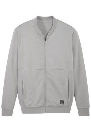 Light grey zip-up jacket with ribbed collar, cuffs, hem, side pockets, and a small black square logo patch on front lower side.