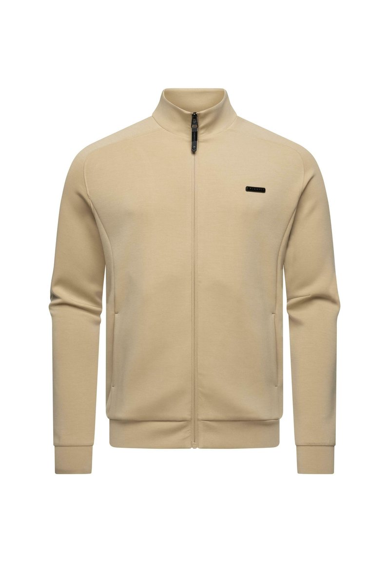 Beige zippová bunda vyrobená z hladkej látky, s vysokým golierom a bočnými vreckami. Čierne logo značky na ľavej hrudi.