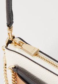 White textured leather purse with gold hardware. Features a zipper closure and a chain strap. Black leather accents along the top.