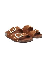 Brown suede sandals featuring two wide straps with gold buckles and dotted accents. Flat cork sole with a textured finish.