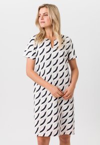Korte mouwen A-lijn jurk in lichte stof, met een golvenpatroon in zwart-wit, een V-hals en een ontspannen pasvorm.