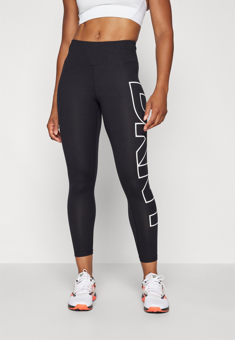 Black leggings with a high waist, featuring a bold white logo on the left side. Made of stretchy material, designed for comfort and performance.