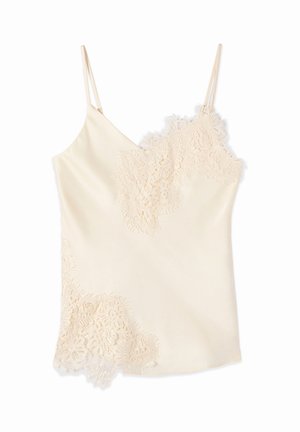 Camisole color crema in raso con dettagli in pizzo floreale smerlato sullo scollo e sull'orlo, dotata di sottili spalline regolabili.