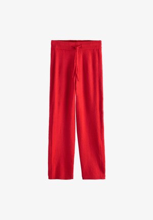 Raudoni, plačios kojų kelnės iš minkštos medžiagos; su elastingu dirželiu ir raišteliu, leidžiančiu reguliuoti dydį. Nėra matomų raštų ar akcentų.