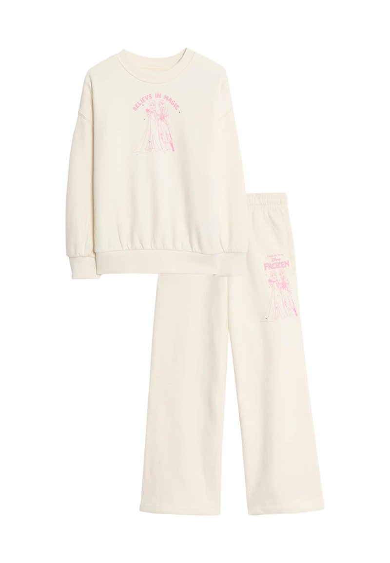 Crème kleurige sweatshirt en sweatpants set met roze grafische tekst "Geloof in Magie" en een personage uit Frozen op beide kledingstukken.