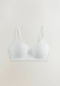 Soutien-gorge sans couture blanc sans fil avec fines bretelles réglables, posé à plat sur une surface claire.