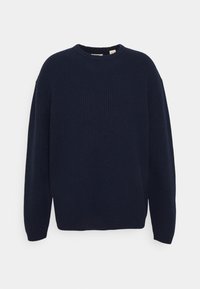 Navyblauer gerippter Pullover mit Rundhalsausschnitt und langen Ärmeln. Weicher Stoff, lockere Passform und minimalistisches Design ohne sichtbare Verschlüsse oder Akzente.