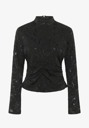 Must peab mustade pika varrukaga topp, millel on tekstuuritud roosimuster, kõrge kaelus ja kogumise detailid vöökohtadel, et luua figuuri rõhutav siluett.