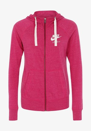 Fuchsia zip-up hoodie with a drawstring hood, kangaroo pockets, and white Nike logo. Soft, textured fabric with a relaxed fit.