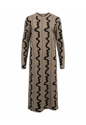 Vestido de punto con mangas largas y un escote redondo. Tela en tono beige con líneas negras onduladas y patrones en zigzag. Diseño hasta el suelo.