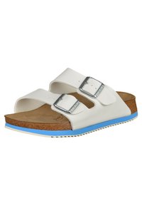 White sandals with two adjustable straps, silver buckles, cork footbed, and a blue accent on the sole. Textured rubber outsole for traction.