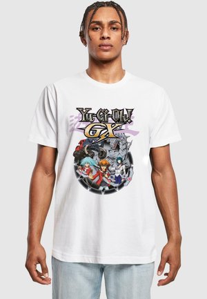 White cotton t-shirt featuring a colorful graphic print of "Yu-Gi-Oh! GX" characters in a circular design with intricate details.