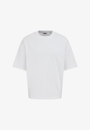 T-shirt blanc uni à manches courtes avec un col rond et une coupe ample, présenté sur un fond blanc.