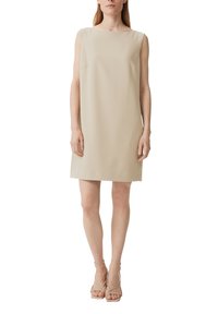 Beiges ärmelloses Kleid mit geradem Schnitt und minimalen Details. Hergestellt aus glattem Stoff, mit U-Boot-Ausschnitt und seitlichen Taschen.