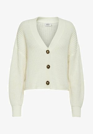 Pletena jopica v kremni barvi z globokim V-izrezom, opremljena s tremi velikimi temnimi gumbi in rebrastimi manšetami. Kratka zasnova z teksturirano tkanino.