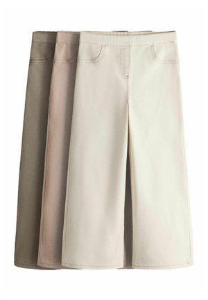 Three midi skirts in beige, light brown, and cream, with front pockets and visible stitching, laid flat overlapping each other.