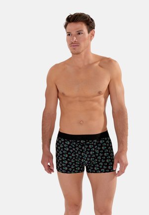 Boxer neri con un motivo a raggi colorati, caratterizzati da una vita elastica nera con logo in rilievo. Tessuto morbido.