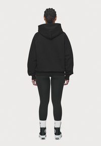 Pegador Jersey con capucha - black