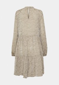 Vestido beige de niveles con mangas largas, tejido suave, espalda con abertura en forma de llave y sutil patrón de hojas en toda la prenda. Cierre con cremallera en la parte posterior.