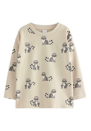 Beige langærmet skjorte med gentagne tegneserielemurer med store øjne og stribede haler i grå og sort.