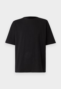 Camiseta negra de manga corta hecha de suave tejido de algodón, con cuello redondo y un corte holgado. Sin logotipos ni patrones visibles.