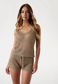 Light brown mesh tank top and shorts set with a loose fit, crafted from a textured material featuring a grid pattern. Drawstring waistband.