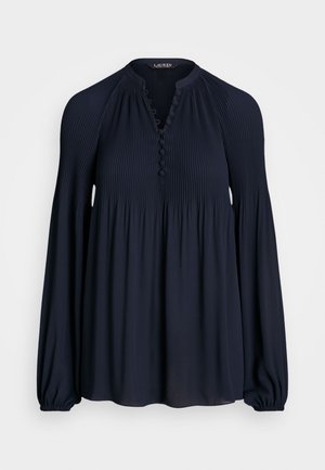 Navy blue long-sleeve blouse, featuring vertical pleats, a buttoned neckline, and elasticized cuffs for a relaxed fit.