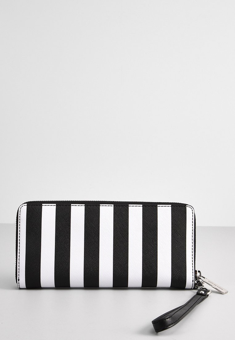Cartera a rayas en blanco y negro con un tejido texturizado, cierre de cremallera y una correa de muñeca negra desmontable. Líneas limpias y acentos cosidos.