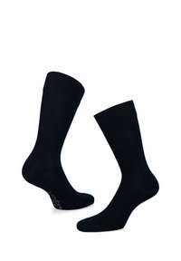 Czarne bawełniane skarpetki o gładkiej fakturze, standardowej długości i prążkowanym ściągaczu, z minimalnym brandingiem na podeszwie.