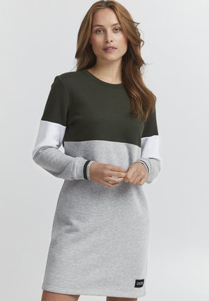 Long-sleeve dress featuring a dark green top, light gray body, and white sleeves. Ribbed cuffs and logo patch at the lower hem. Soft fabric.