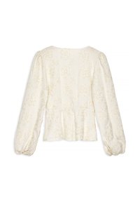 Blusa color crema con ricami floreali testurizzati, maniche a sbuffo e vita a peplo. Tessuto morbido con una leggera lucentezza.