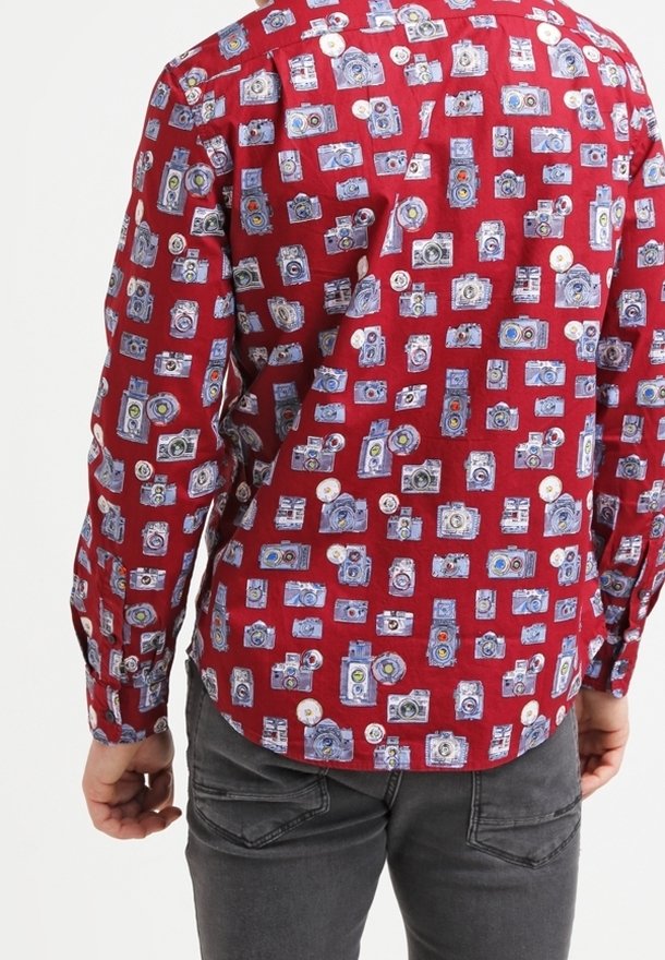 Red button-up shirt featuring a pattern of vintage cameras in blue and white, with complementary buttons and a soft fabric texture.