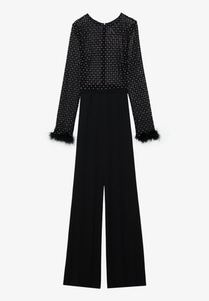 Combinaison noire à manches longues, corsage orné de cristaux et détails en plumes au niveau des poignets. Design à jambes larges, silhouette élégante.
