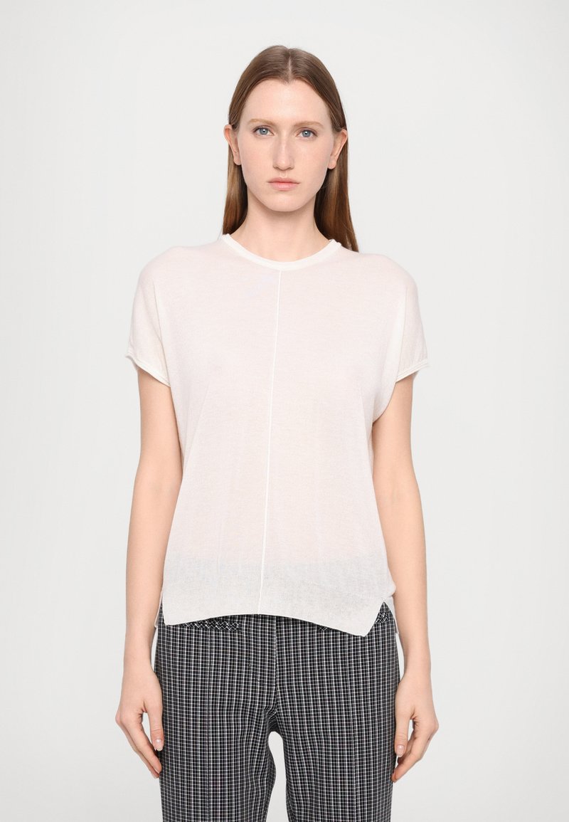 Lightweight, short-sleeve top in soft, sheer white fabric with a rounded neckline. Features a straight cut and slightly curved hem.
