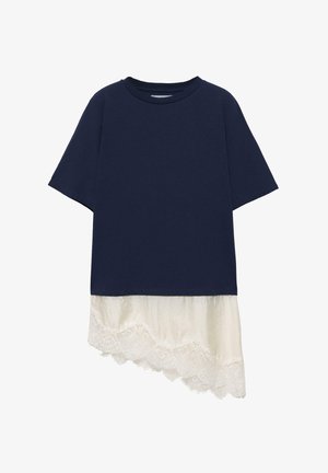 Mørkeblå top med korte ærmer og asymmetrisk hvid blondekant, der rækker under skjortens nederste kant.