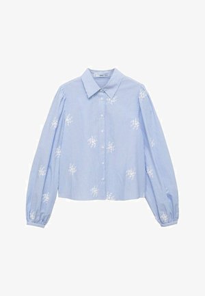 Niebieska i biała w paski koszula zapinana na guziki, z długimi rękawami i haftem kwiatowym. Posiada klasyczny kołnierzyk oraz zmarszczone mankiety.