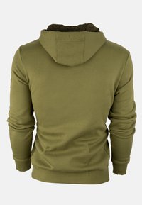 Olivenfarbene Kapuzenjacke mit einem gemusterten schwarzen Futter in der Kapuze, gerippten Bündchen und Saum sowie einer lässigen Passform. Glatte Stoffoberfläche.