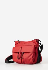 Red nylon crossbody bag with two front pockets, black zippers, adjustable strap, and a smooth texture. Features curved top and flat base.