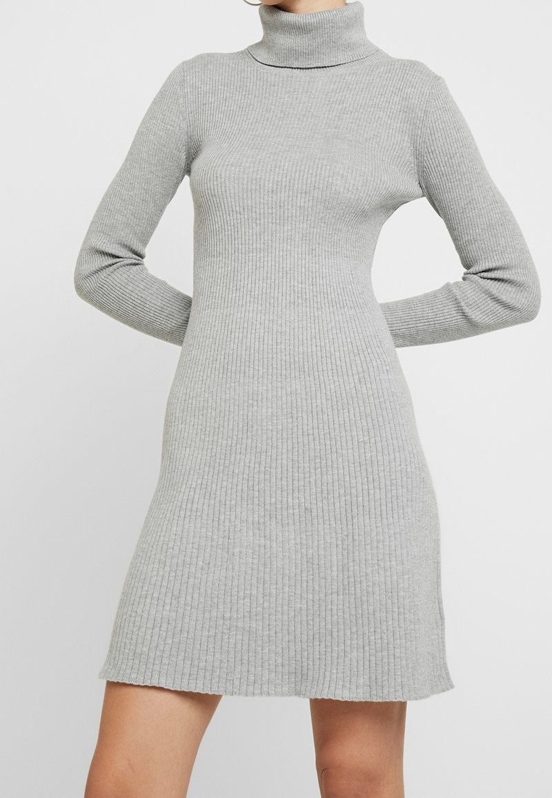 Gray ribbed knit dress with a high collar and long sleeves, featuring a fitted bodice and a slightly flared skirt.