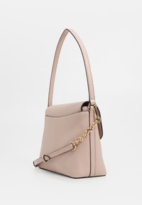 Borsa in pelle texturizzata rosa chiaro con manico lungo e tracolla removibile, caratterizzata da un dettagli in catena dorata, mostrata su uno sfondo bianco.