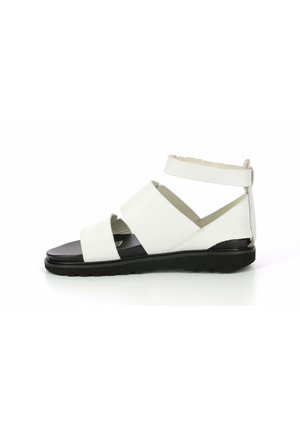 White sandal with wide crossover straps and a secure ankle strap, black sole, smooth leather material, flat design, and minimal detailing.