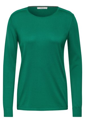 Haut vert à manches longues en matériau lisse et léger. Il possède un col rond et des manches ajustées avec des poignets côtelés.
