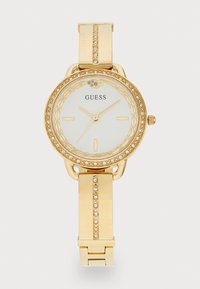 Gold wristwatch with a round face, white dial, gold hour markers, and a crystal-encrusted bezel. Features a metal band with accent stones.
