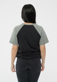 Paradiso Clothing NIRVANA IN UTERO ANGELIC RAGLAN - Print T-shirt - black