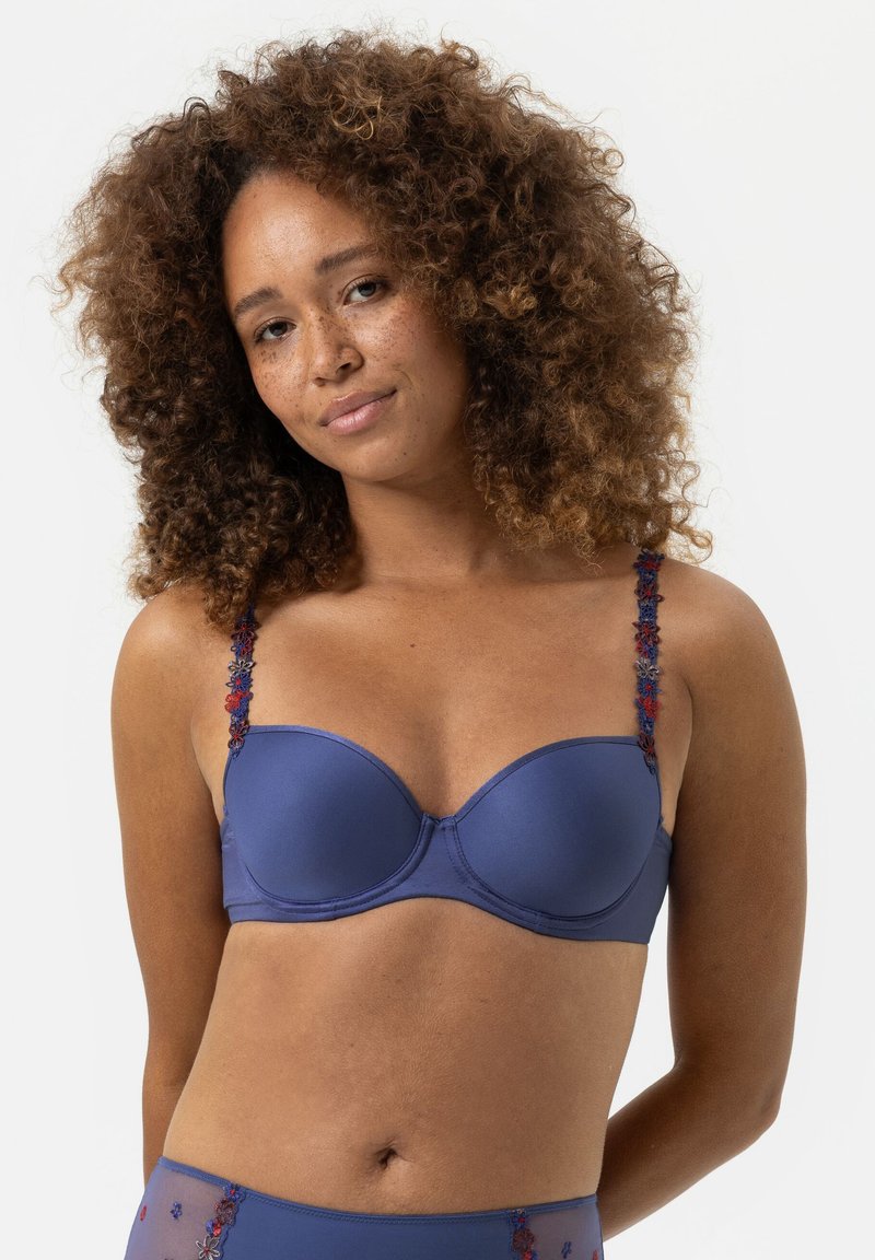 Polstrovaná modro-námořnická podprsenka s květinovým vyšívaným ramínkem. Hladká tkanina s kosticemi a bezešvý design pro klasický siluetu.
