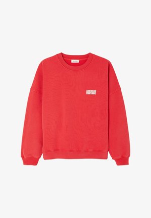 Raudonas džemperis, pagamintas iš minkštos medžiagos, su apvalia iškirpte, ilgomis rankovėmis ir balta "AMERICAN VINTAGE" logo ant krūtinės.