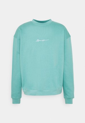 Felpa turchese con scollo rotondo e maniche lunghe. Presenta un logo bianco scritto a mano sul petto. Realizzata in morbido tessuto misto cotone.