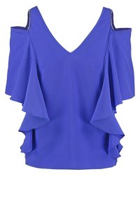 Blå kallaxel-blus med volangärmar och V-ringning, med dekorativa remmar på axlarna.