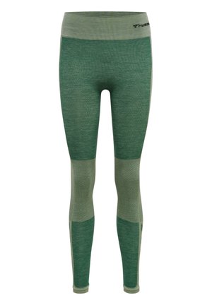 Grüne Leggings mit strukturiertem Finish und gemusterten Einsätzen. Mit breitem Bund und unterschiedlichen Grüntönen. Leichtes Material.