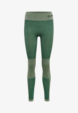 Grüne Leggings mit strukturiertem Finish und gemusterten Einsätzen. Mit breitem Bund und unterschiedlichen Grüntönen. Leichtes Material.